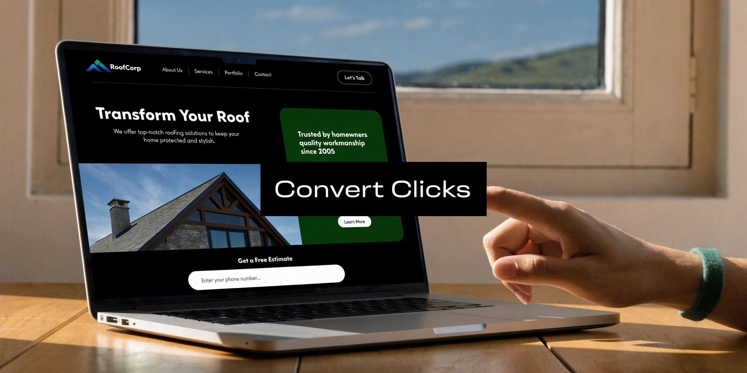 A person using a laptop to view a roofing company website while working on a wooden table.