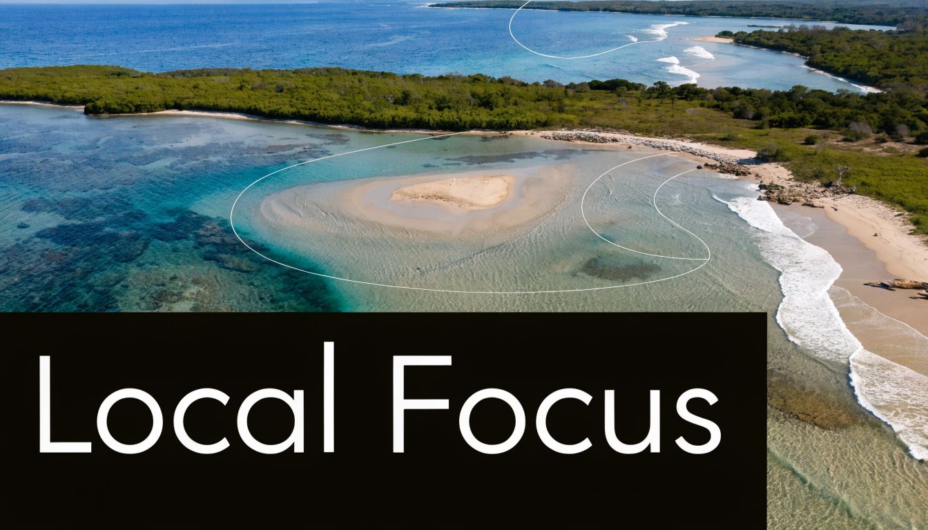 An aerial view of a secluded tropical beach with clear turquoise water and a small sandy islet.